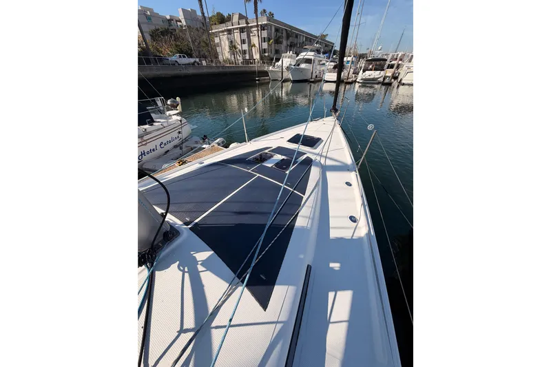 First 36 Yacht Photos Pics 2023 Beneteau First 36 sailboat docked in a marina, showcasing sleek deck design.