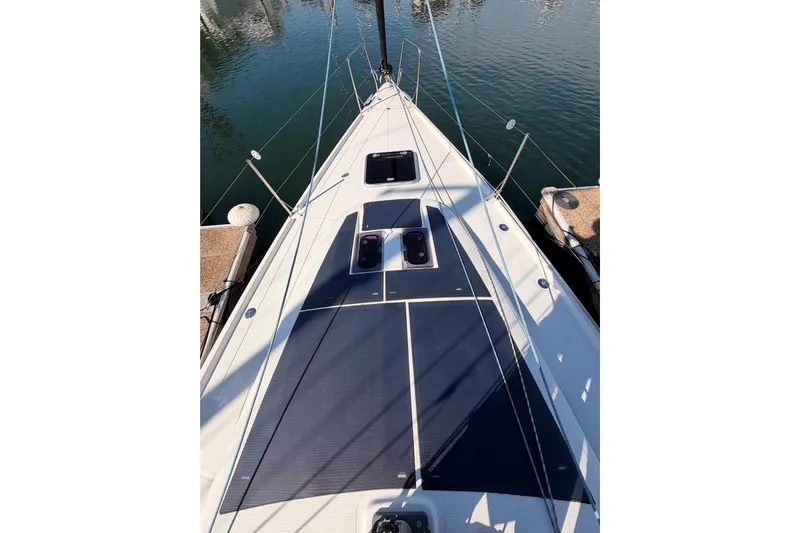 First 36 Yacht Photos Pics 2023 Beneteau First 36 sailboat deck, docked in a marina, showcasing sleek design.