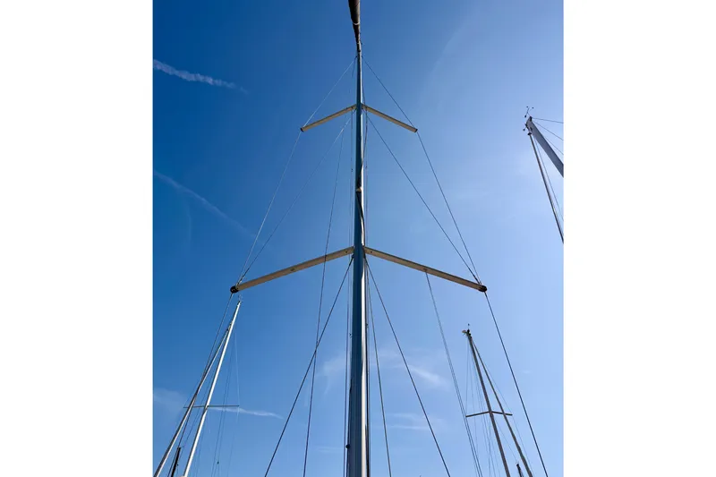 First 36 Yacht Photos Pics Mast of 2023 Beneteau First 36 sailboat against clear blue sky.