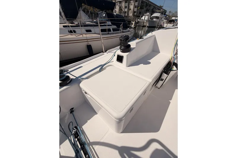 First 36 Yacht Photos Pics 2023 Beneteau First 36 sailboat deck with winch and seating area in marina.