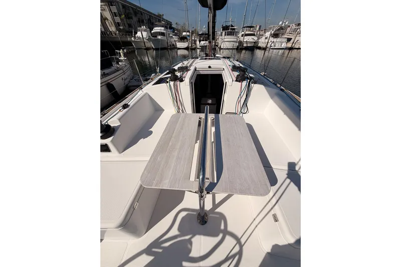 First 36 Yacht Photos Pics 2023 Beneteau First 36 sailboat cockpit with table, docked in marina.