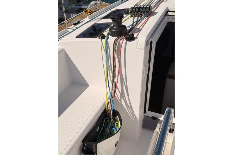 First 36 Yacht Photos Pics 2023 Beneteau First 36 sailboat deck with colorful ropes and winch system.