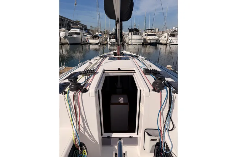First 36 Yacht Photos Pics 2023 Beneteau First 36 sailboat docked in marina, showcasing deck and rigging.