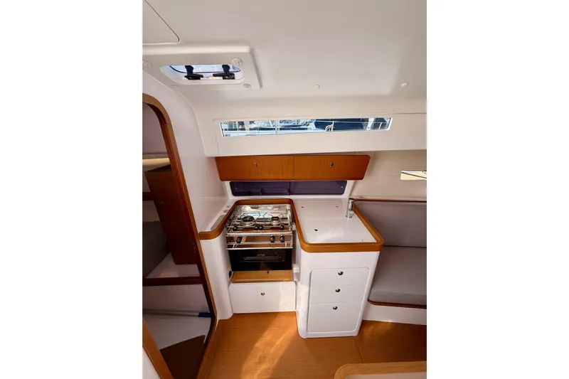 First 36 Yacht Photos Pics 2023 Beneteau First 36 yacht interior with modern kitchen and seating area.