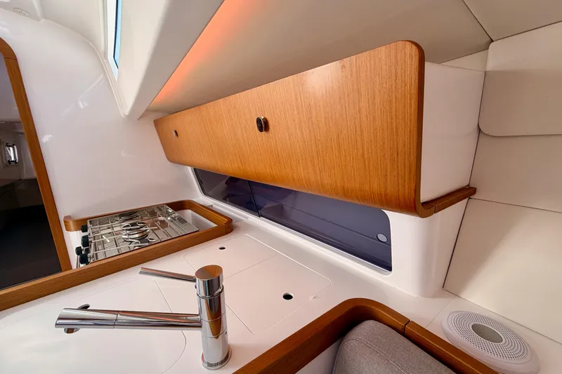 First 36 Yacht Photos Pics Modern kitchen interior of 2023 Beneteau First 36 yacht with sleek wood cabinetry.