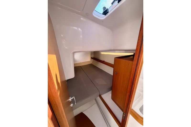First 36 Yacht Photos Pics 2023 Beneteau First 36 cabin interior with wooden accents and a skylight.