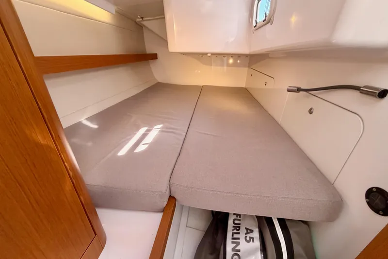 First 36 Yacht Photos Pics 2023 Beneteau First 36 cabin interior with cushioned berth and storage space.