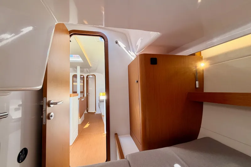 First 36 Yacht Photos Pics 2023 Beneteau First 36 interior cabin with modern wood finish and cozy lighting.