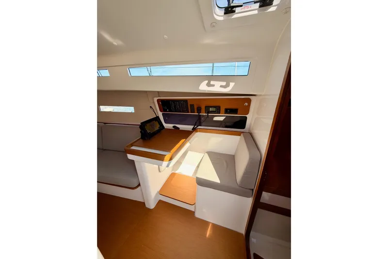 First 36 Yacht Photos Pics Interior of 2023 Beneteau First 36 sailboat, featuring navigation station and seating area.