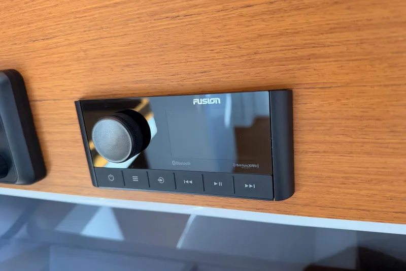 First 36 Yacht Photos Pics Fusion audio system on 2023 Beneteau First 36 yacht, mounted on wooden panel.