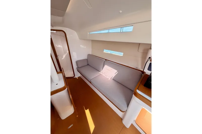 First 36 Yacht Photos Pics Interior of 2023 Beneteau First 36 yacht, featuring a modern, minimalist design with a comfortable sofa.
