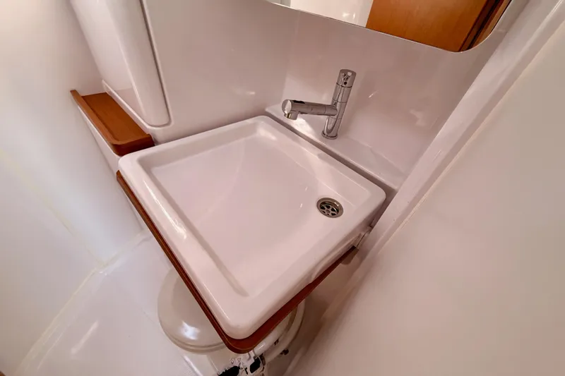 First 36 Yacht Photos Pics Modern bathroom sink in 2023 Beneteau First 36 yacht, featuring sleek design and wood accents.