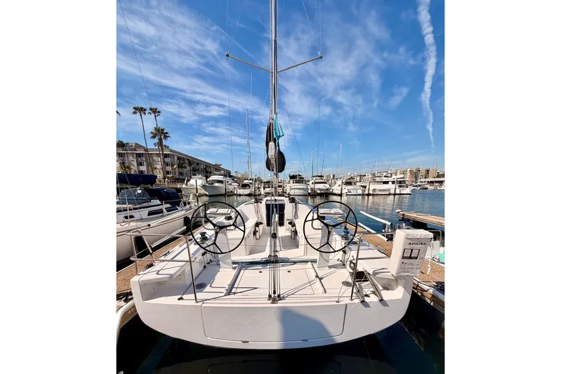 First 36 Yacht Photos Pics 2023 Beneteau First 36 sailboat docked at a marina under a clear blue sky.