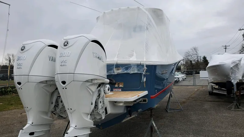  Yacht Photos Pics 2023 Regulator 28 boat with twin Yamaha engines, covered and on display outdoors.