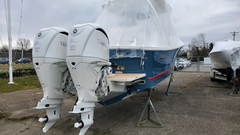 Yacht Photos Pics 2023 Regulator 28 boat with twin Yamaha outboard engines, covered and elevated on stands.