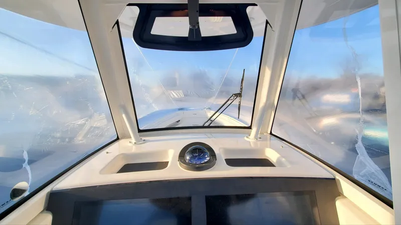  Yacht Photos Pics 2023 Regulator 28 boat cockpit view with clear windshield and dashboard instruments.
