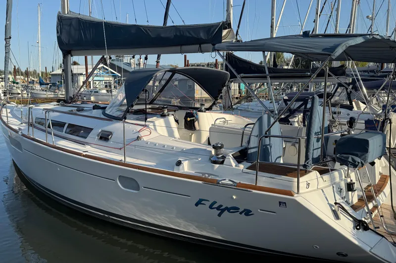Flyer Yacht Photos Pics 2010 Jeanneau Sun Odyssey 44i sailboat docked in marina, featuring sleek design and spacious deck.