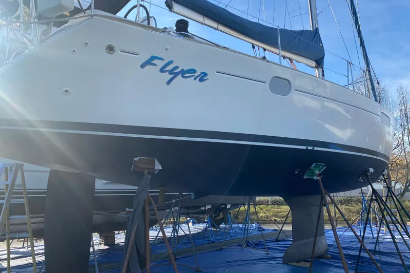 Flyer Yacht Photos Pics 2010 Jeanneau Sun Odyssey 44i sailboat named "Flyer" on dry dock under sunlight.