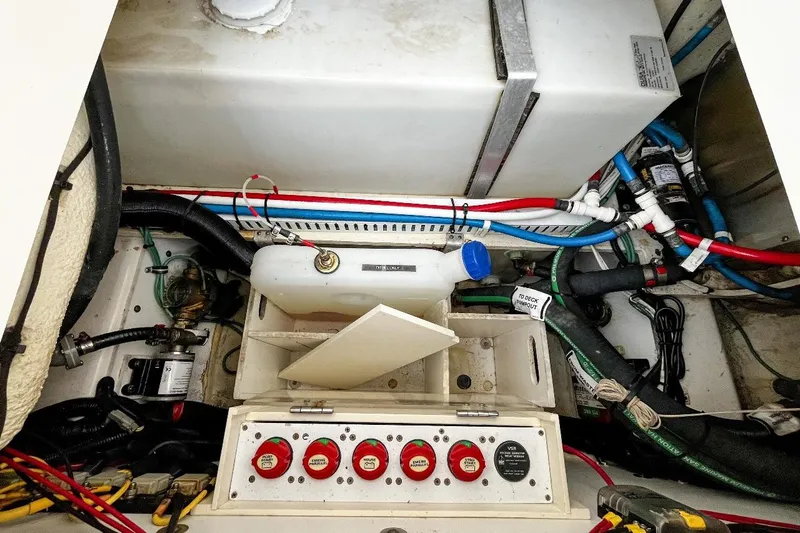  Yacht Photos Pics 2014 Pursuit OS 285 Offshore engine compartment with wiring and fluid containers.