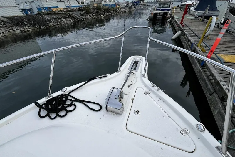  Yacht Photos Pics 2014 Pursuit OS 285 Offshore boat docked at marina, view from bow.