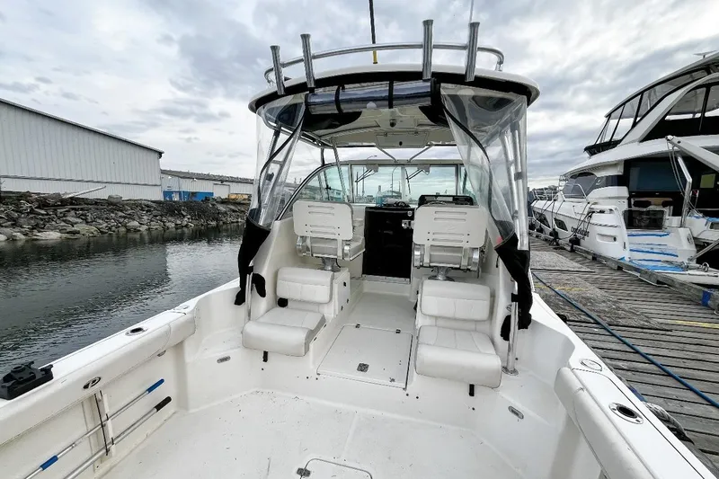  Yacht Photos Pics 2014 Pursuit OS 285 Offshore boat docked, featuring spacious seating and modern design.