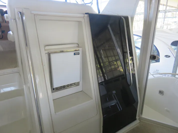 Nepenthe Yacht Photos Pics 2003 Carver 366 Motor Yacht interior with compact refrigerator and sleek black door.