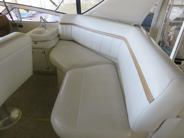 Nepenthe Yacht Photos Pics 2003 Carver 366 Motor Yacht interior with white leather seating and compact sink area.
