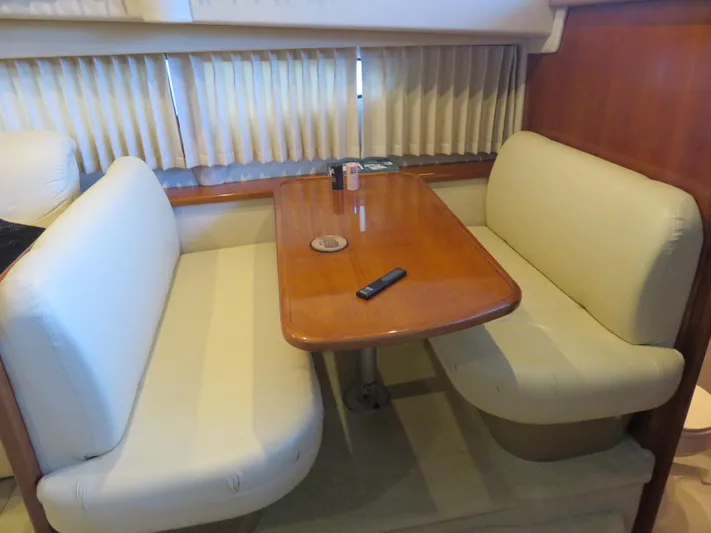 Nepenthe Yacht Photos Pics 2003 Carver 366 Motor Yacht interior with dining area and wooden table.