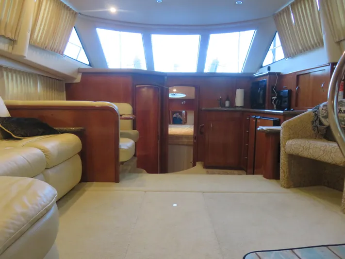 Nepenthe Yacht Photos Pics Interior of 2003 Carver 366 Motor Yacht with luxurious seating and wooden cabinetry.