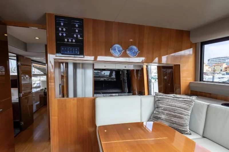  Yacht Photos Pics Luxurious interior of 2016 Princess 82 yacht with wood paneling and plush seating.