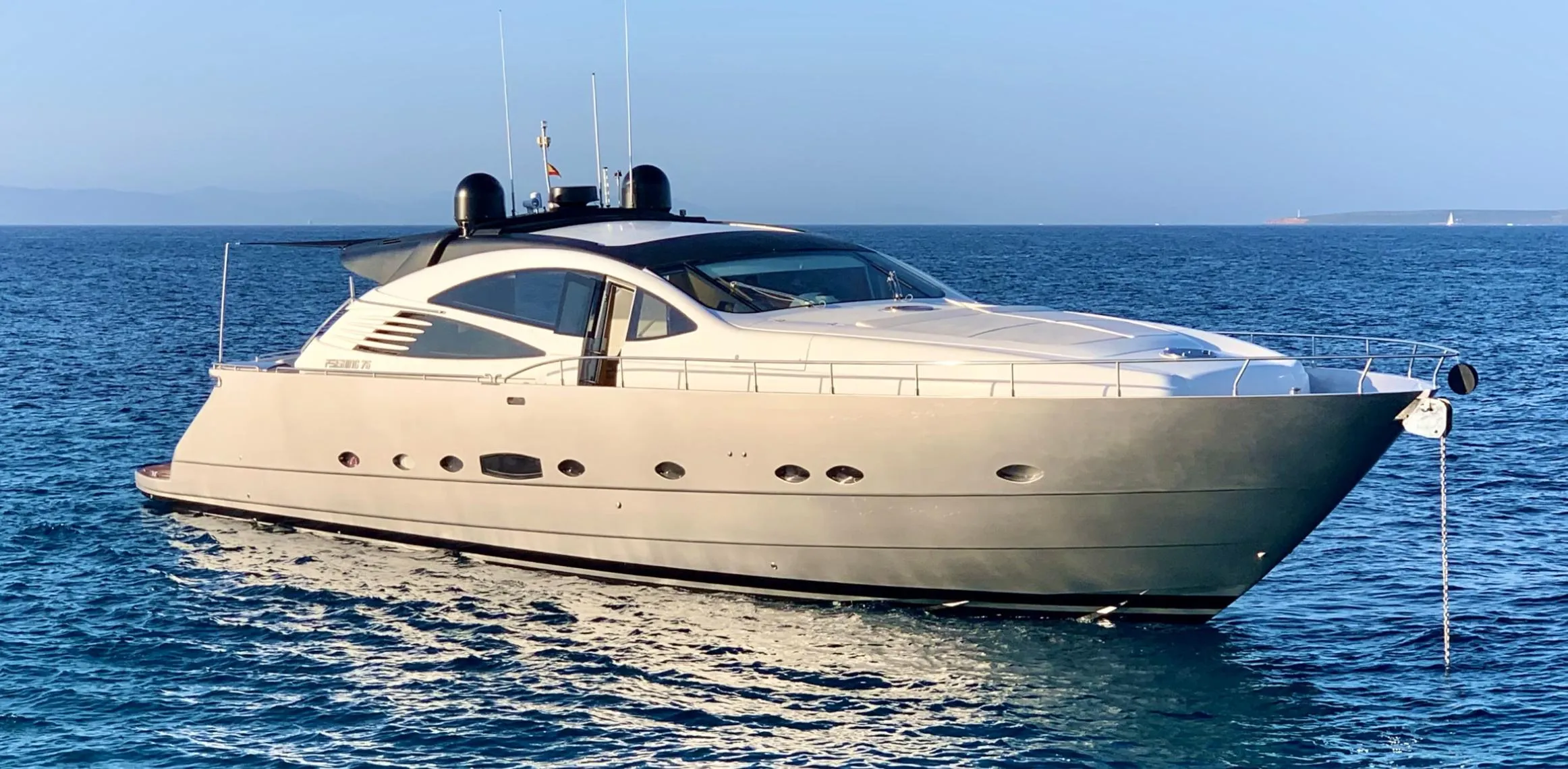 Luxury 2005 Pershing 76 yacht cruising on calm blue waters.