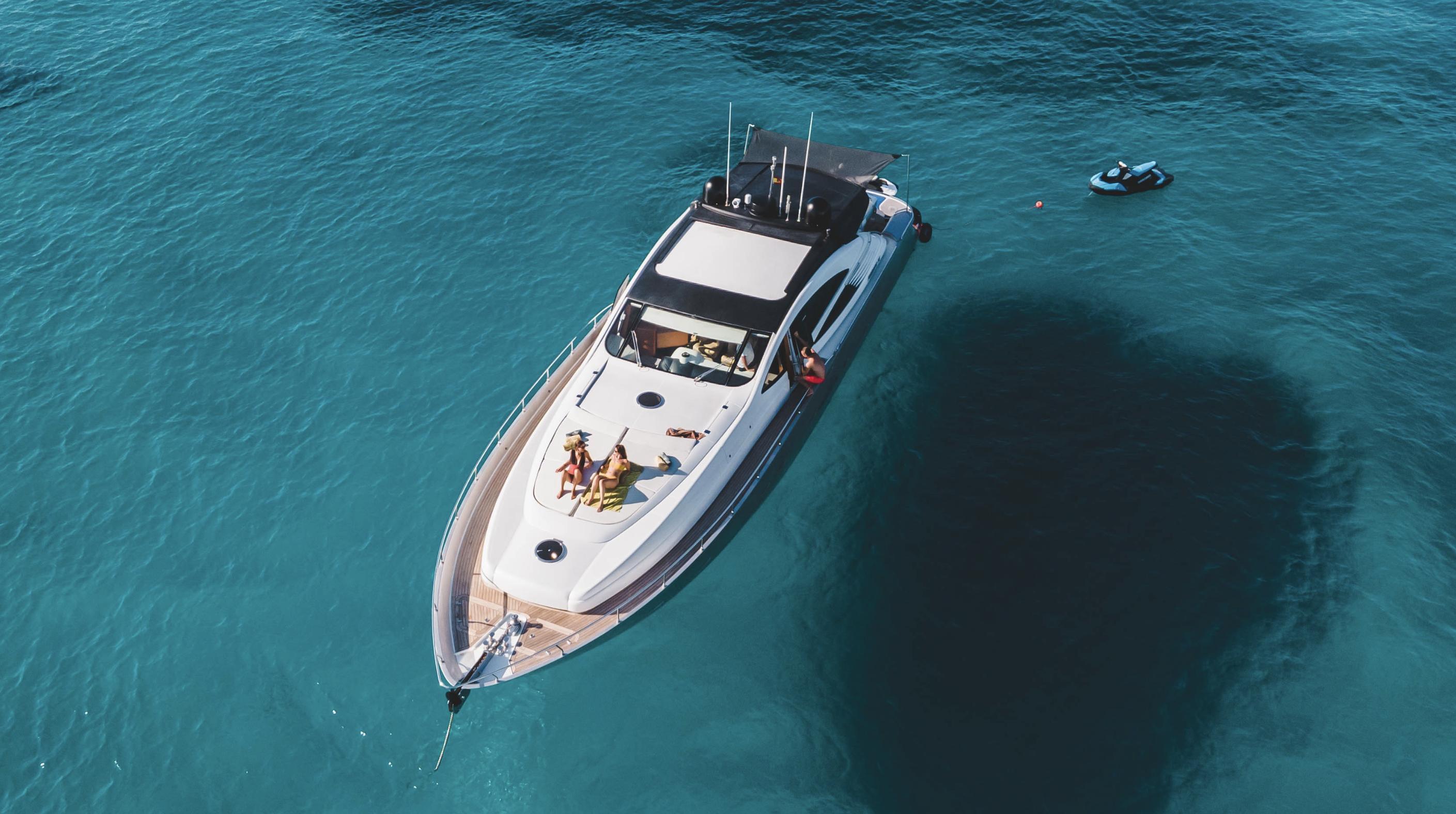 Aerial view of 2005 Pershing 76 yacht on clear blue water.