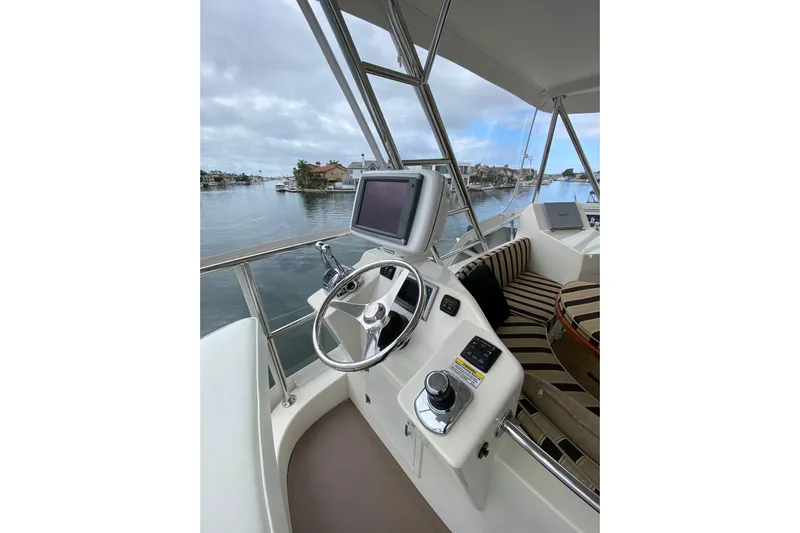  Yacht Photos Pics Helm of 2012 Mikelson 43 Sportfisher with steering wheel and navigation screen.