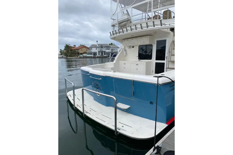  Yacht Photos Pics 2012 Mikelson 43 Sportfisher docked, showcasing spacious deck and sleek design.