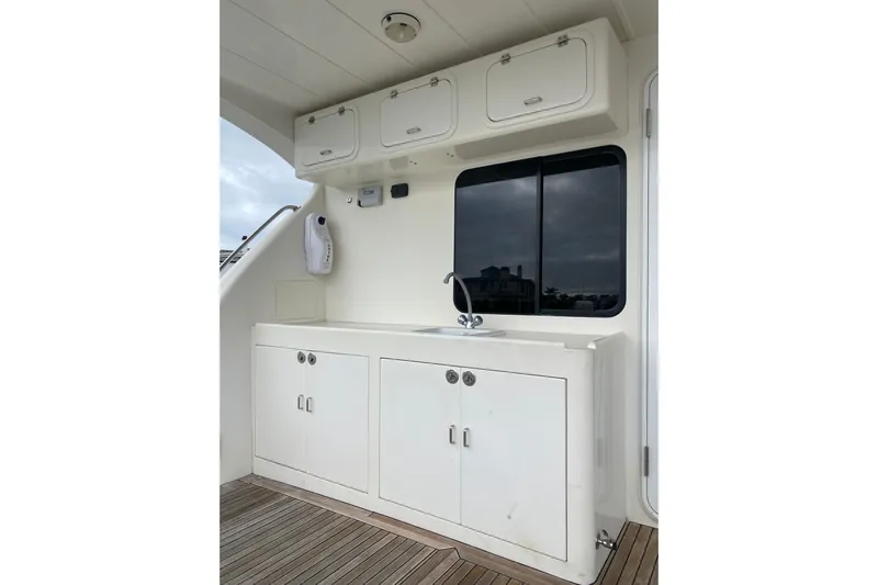  Yacht Photos Pics 2012 Mikelson 43 Sportfisher yacht interior with white cabinetry and sink.