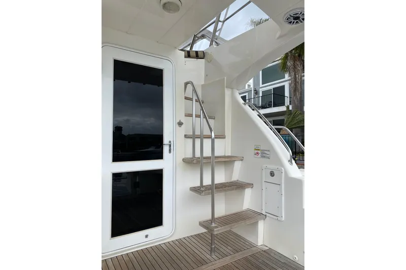  Yacht Photos Pics Stainless steel stairs on 2012 Mikelson 43 Sportfisher yacht, leading to upper deck.