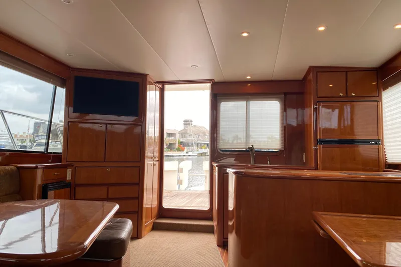  Yacht Photos Pics Luxurious interior of 2012 Mikelson 43 Sportfisher yacht with wood finishes and modern amenities.
