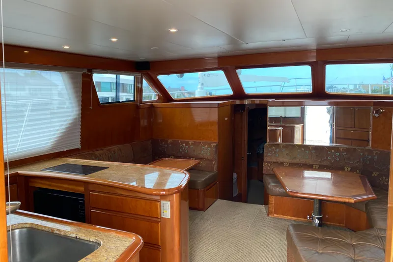  Yacht Photos Pics Luxurious interior of 2012 Mikelson 43 Sportfisher yacht with wood finishes and seating area.