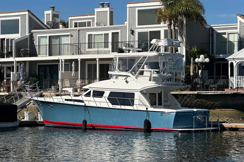  Yacht Photos Pics 2012 Mikelson 43 Sportfisher yacht docked by waterfront homes.