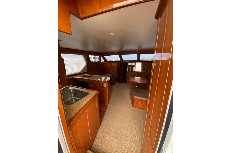  Yacht Photos Pics Interior of 2012 Mikelson 43 Sportfisher yacht with wood finishes and modern amenities.