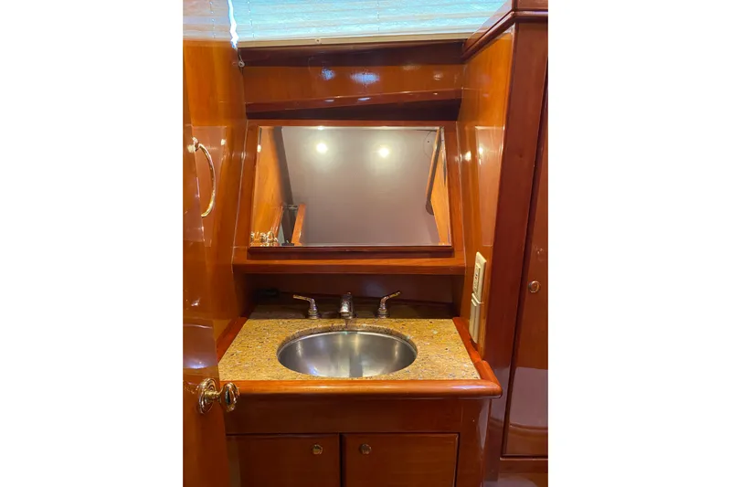  Yacht Photos Pics Luxurious wooden vanity with sink in 2012 Mikelson 43 Sportfisher yacht bathroom.