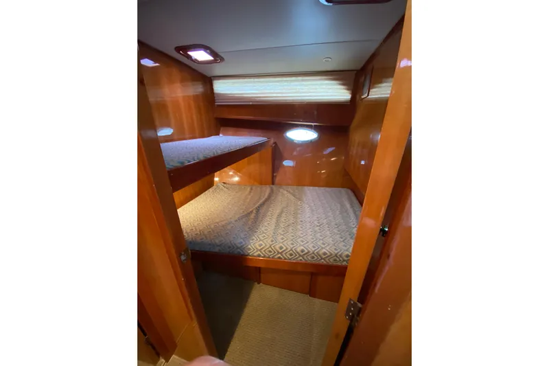  Yacht Photos Pics Cozy cabin with bunk beds in 2012 Mikelson 43 Sportfisher yacht.