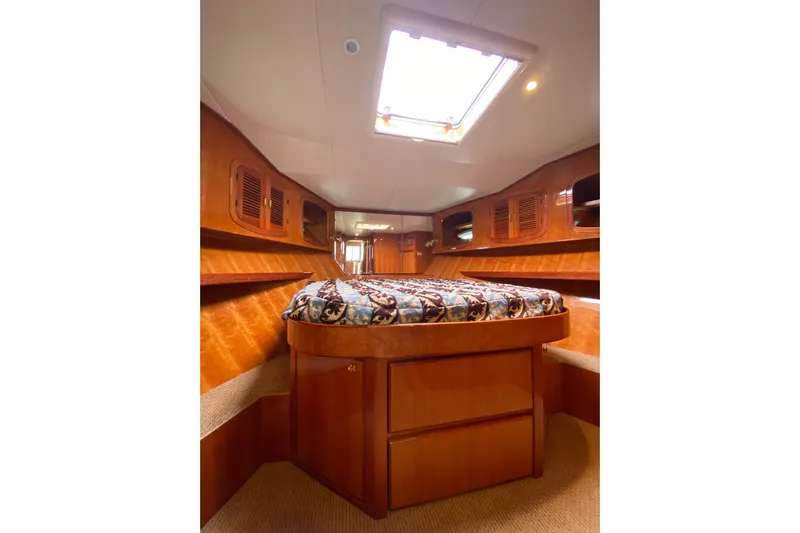 Yacht Photos Pics Luxurious cabin interior of 2012 Mikelson 43 Sportfisher with elegant wood finish.