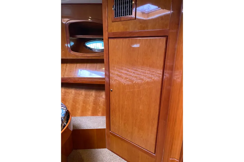  Yacht Photos Pics Interior of 2012 Mikelson 43 Sportfisher with polished wood finish and porthole.