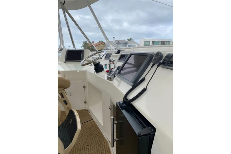  Yacht Photos Pics 2012 Mikelson 43 Sportfisher helm with navigation screens and steering wheel.