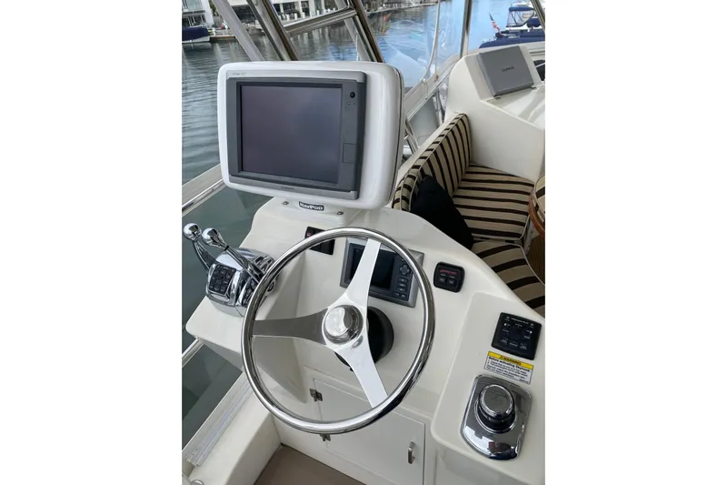  Yacht Photos Pics Helm of 2012 Mikelson 43 Sportfisher with steering wheel and navigation display.