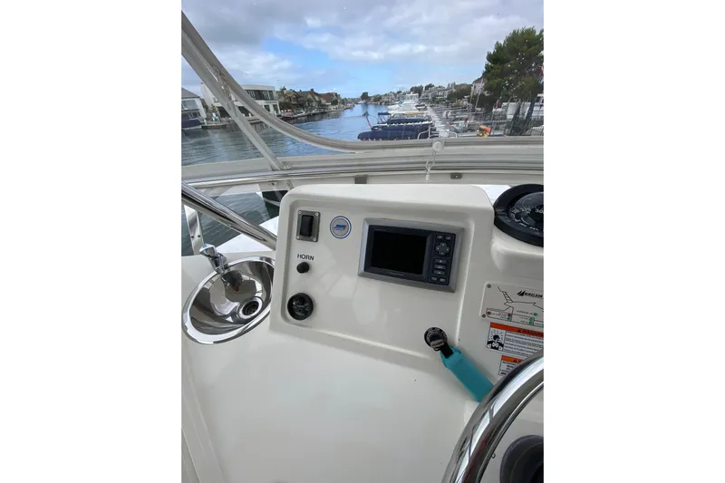  Yacht Photos Pics Control panel of a 2012 Mikelson 43 Sportfisher boat with waterway view.