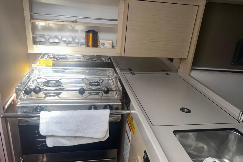 Al Di La Yacht Photos Pics Compact kitchen in a 2020 Beneteau Oceanis 30.1 yacht with stove and sink.