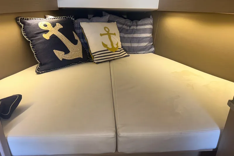 Al Di La Yacht Photos Pics Cozy cabin interior of 2020 Beneteau Oceanis 30.1 with nautical-themed pillows.