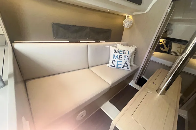 Al Di La Yacht Photos Pics Interior of 2020 Beneteau Oceanis 30.1 yacht with cozy seating and nautical decor.